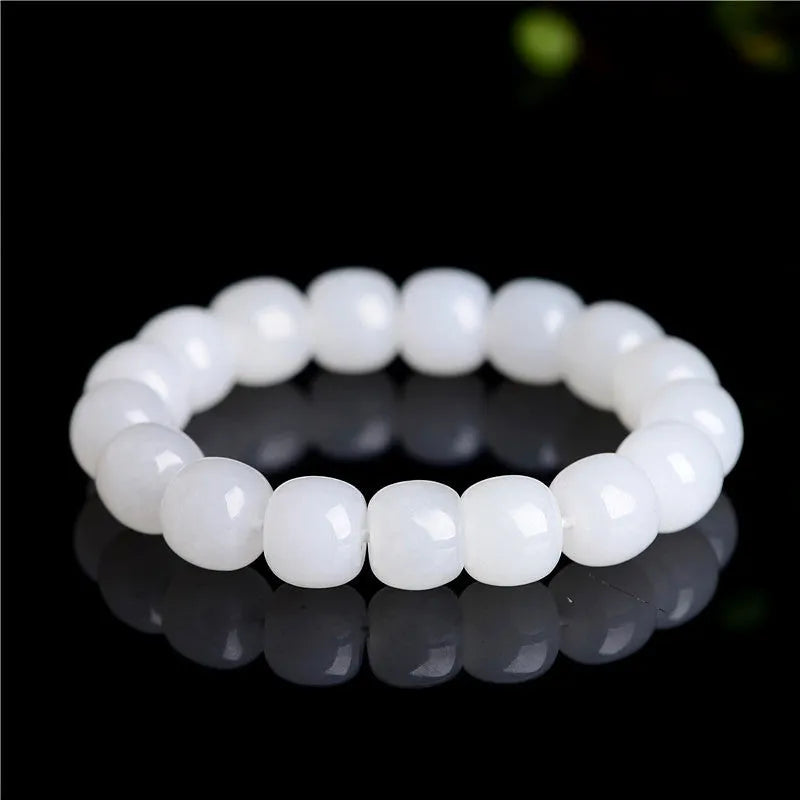 White Hetian jade barrel bead bracelet laid flat, showing unisex casual design.