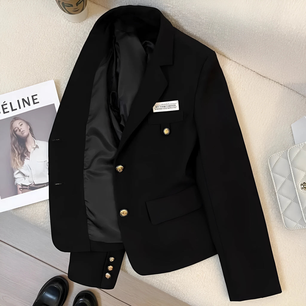 Women's loose fit short suit coat in black polyester fabric with pockets.