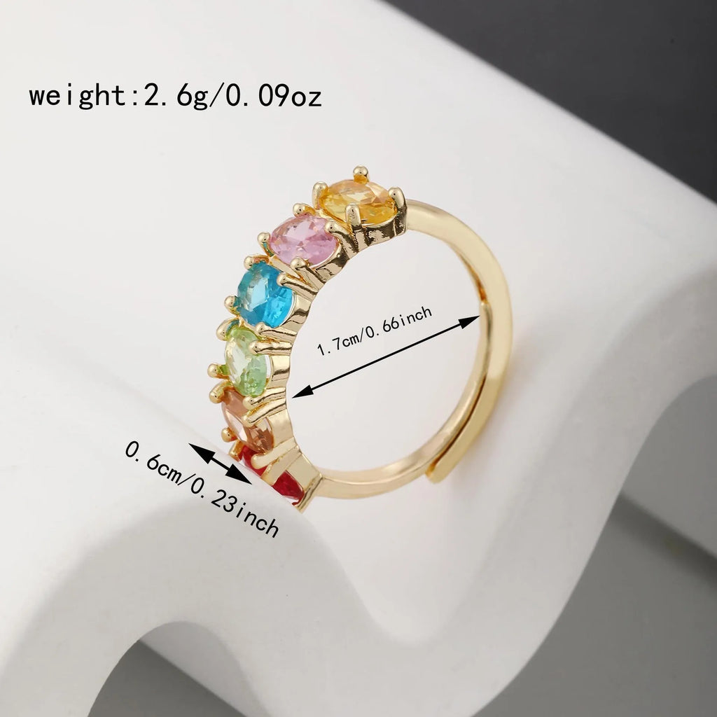 Adjustable gold women's ring with zircon accent on white background