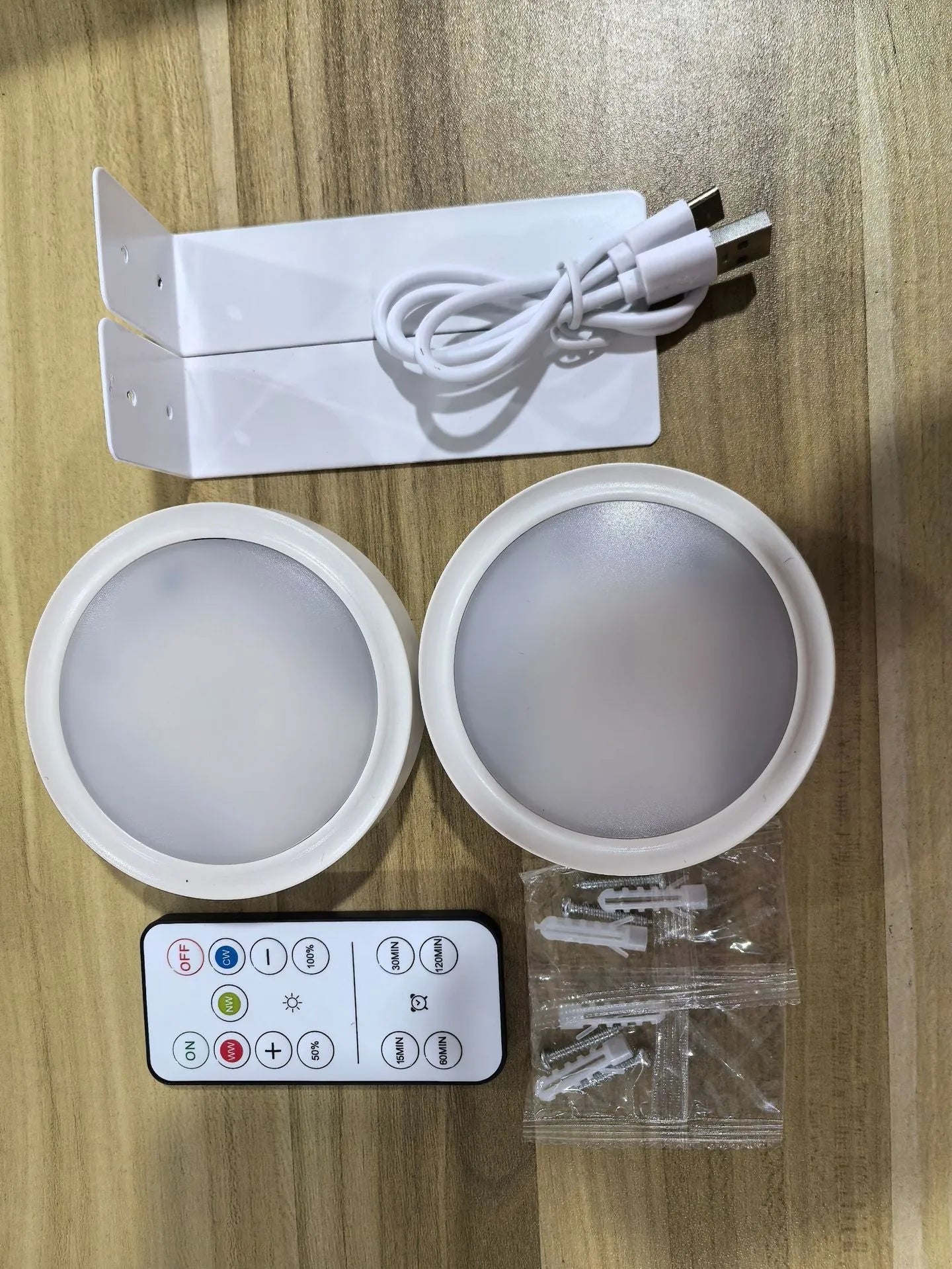 Wireless rechargeable LED painting lamp with magnetic belt attached to a metal frame, remote control nearby.
