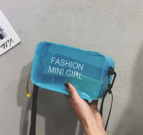 Transparent square women's shoulder bag in jelly material with a diagonal cross strap, showing internal mobile phone pocket.