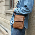 Men's brown genuine leather crossbody shoulder bag with visible stitching details