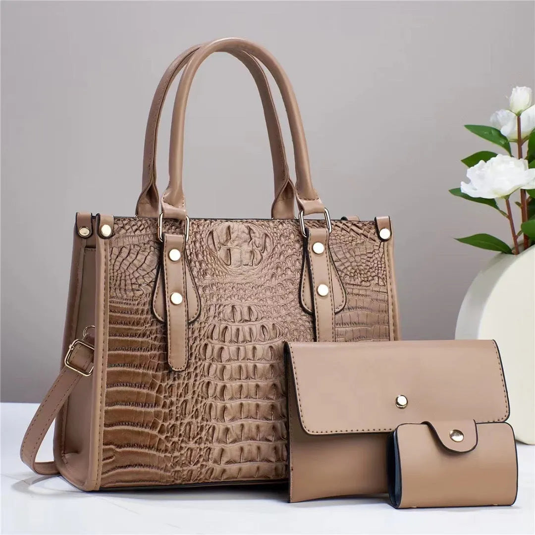 Women's textured PU leather three-piece travel bag set showing crossbody bag, wallet and card holder in coordinated colour