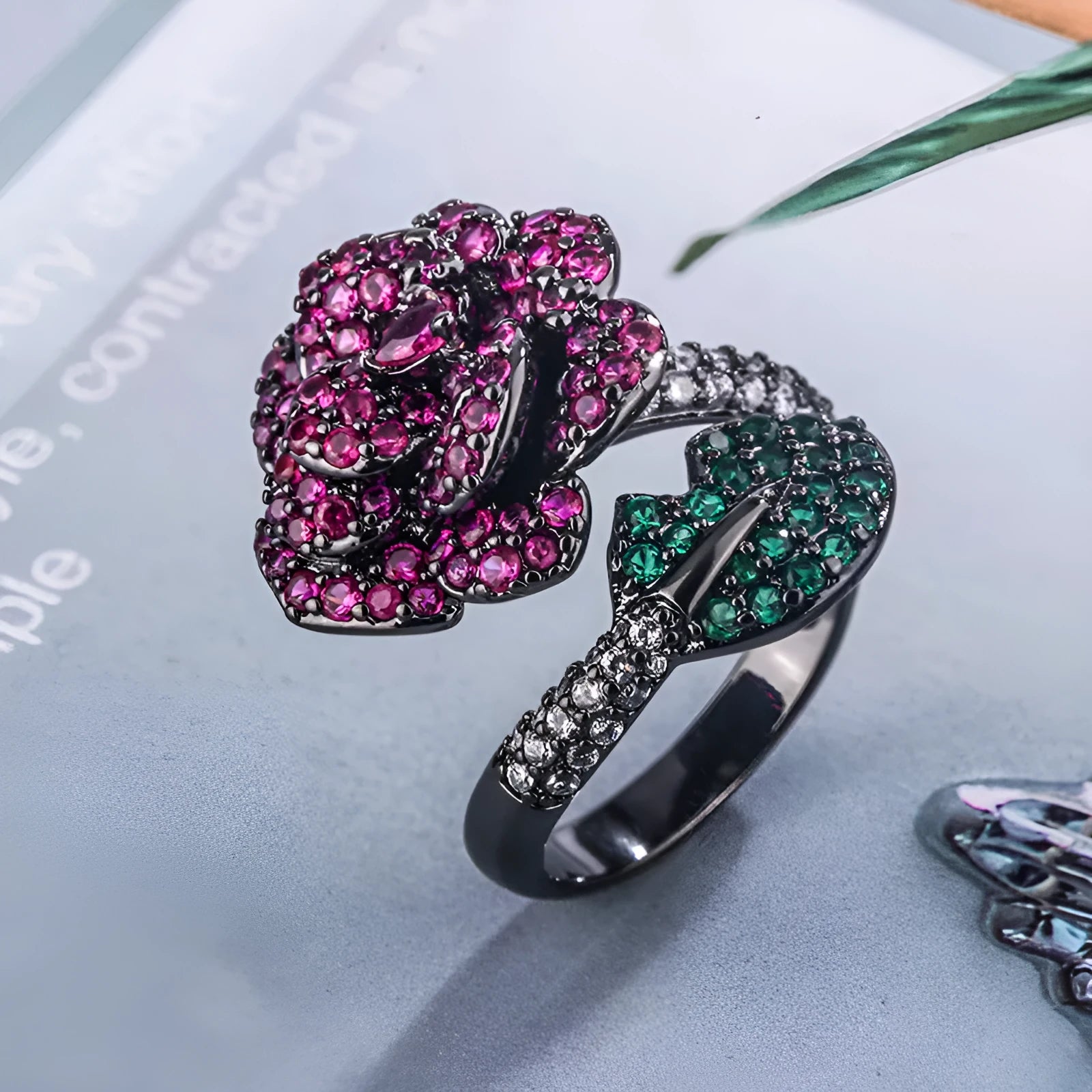 Gold-plated geometric flower ring with red simulated corundum stone on black gold band