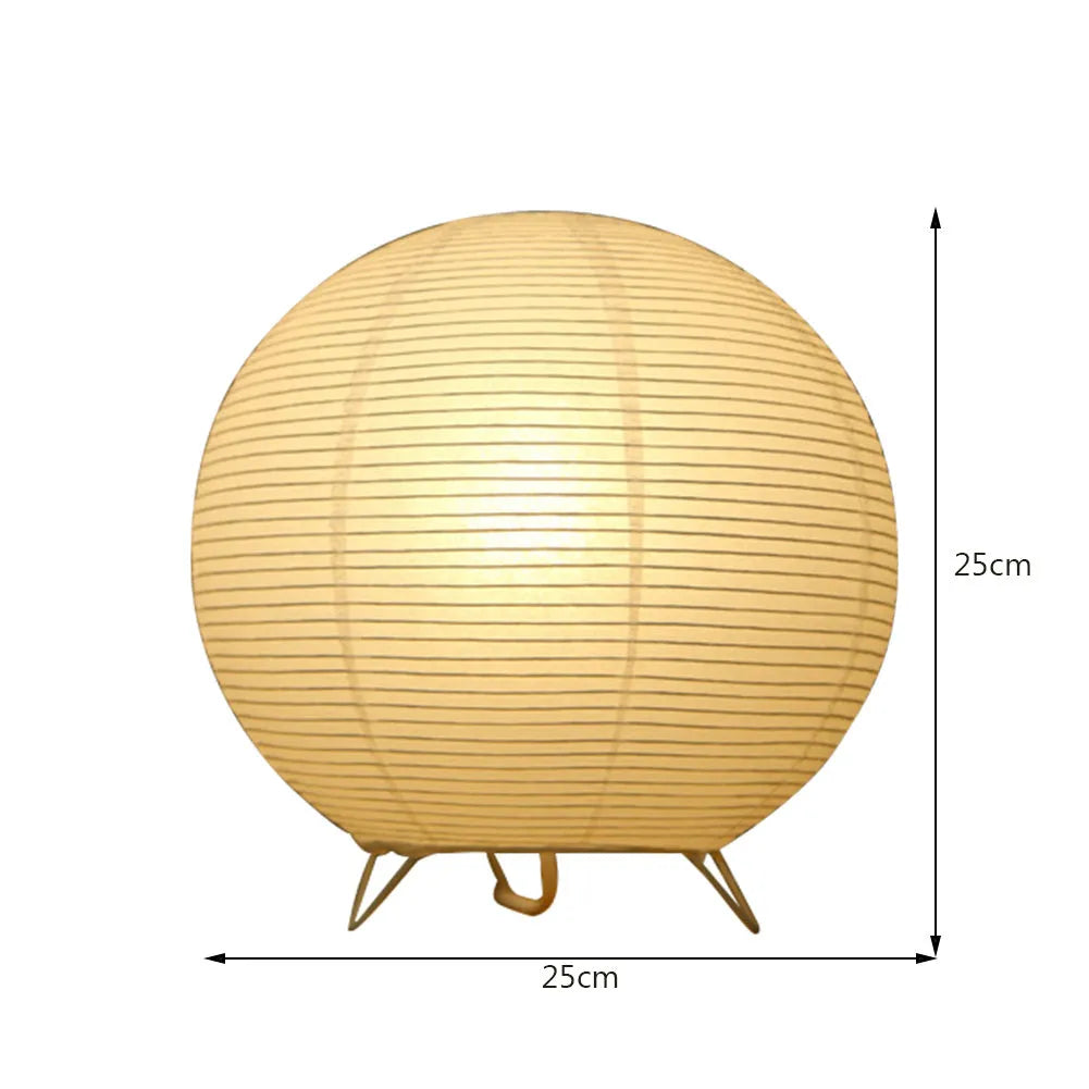 Small white table lamp with rice paper shade on bedside table, circular shape, traditional handwork