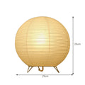 Small white table lamp with rice paper shade on bedside table, circular shape, traditional handwork