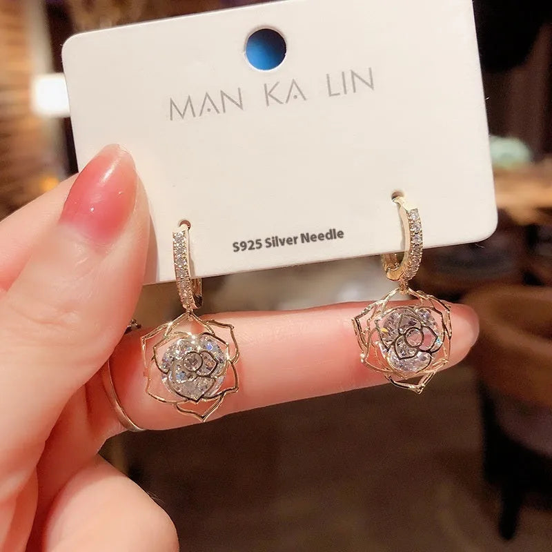 Women's geometric copper earrings with zircon and rose design elements in various colours