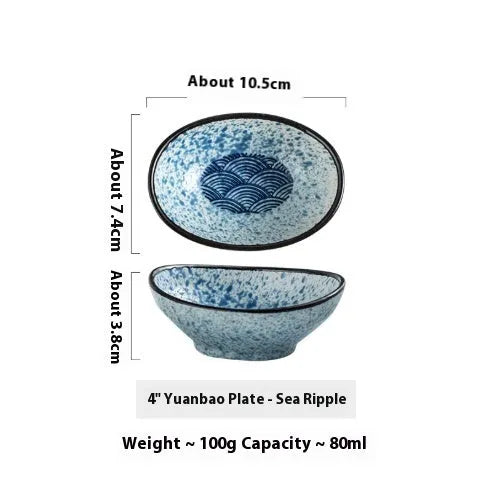 Oval Japanese ceramic sauce dipping bowl with underglaze finish on a table.