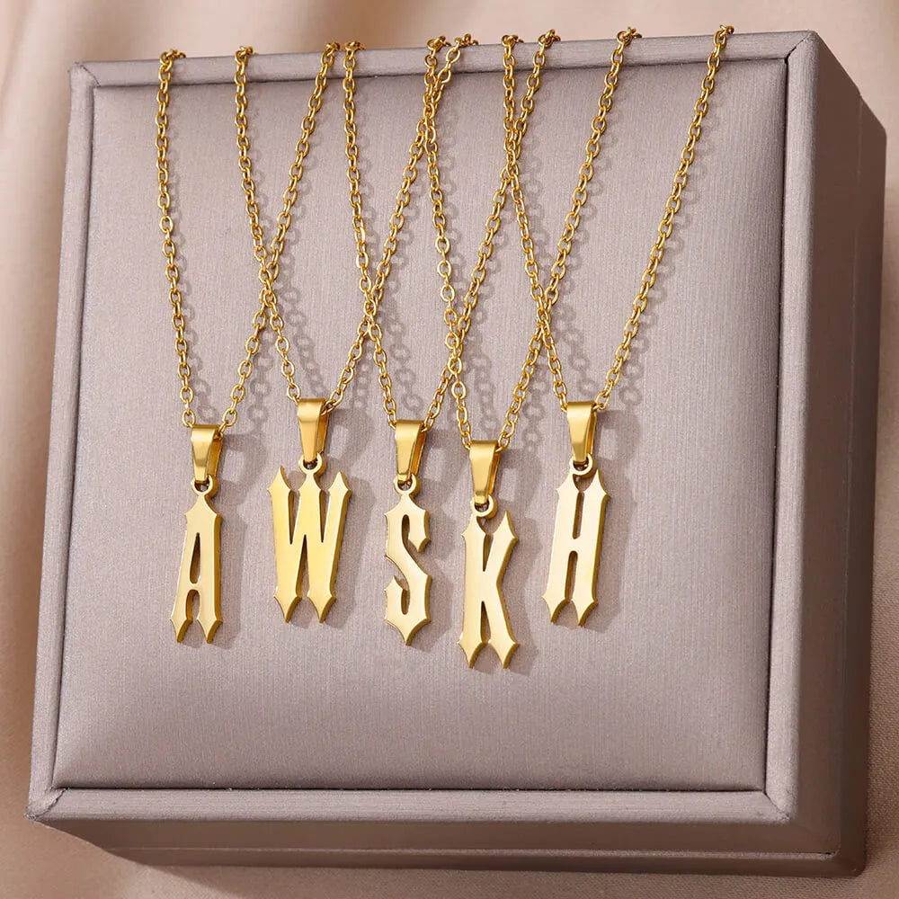 Gold stainless steel ancient English letter pendant necklace with O-ring chain on white background