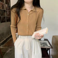 Long-sleeved loose knitted cardigan top in viscose fibre, shown in a neutral colour on a hanger.