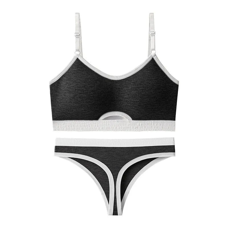 Women's contrast back sports bra vest and briefs set in black with underwire and padding.