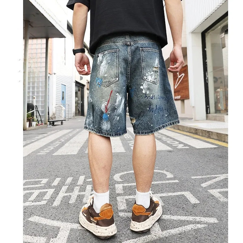 Men's blue ripped denim jeans shorts with graffiti print and straight leg design