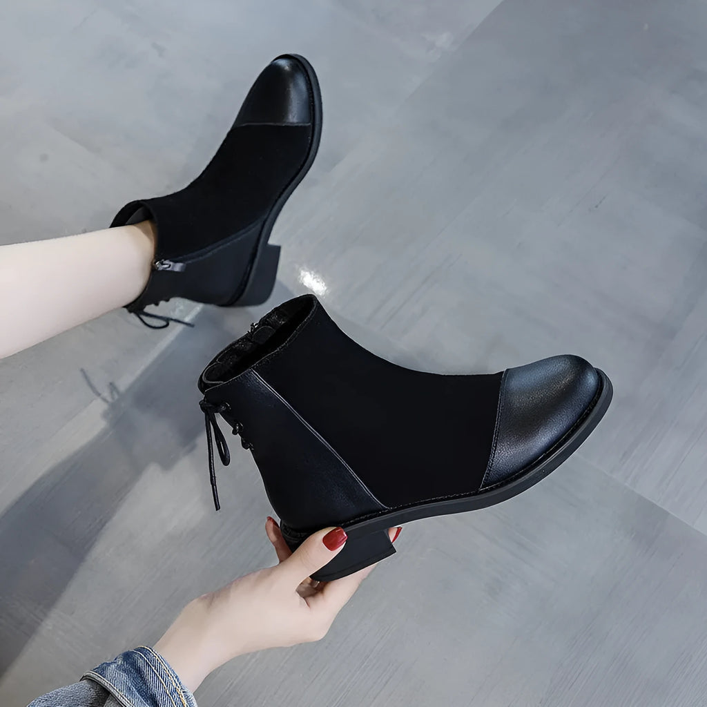 Black women's knee-high Martin boots with side zipper, round toe, and short stout heel.