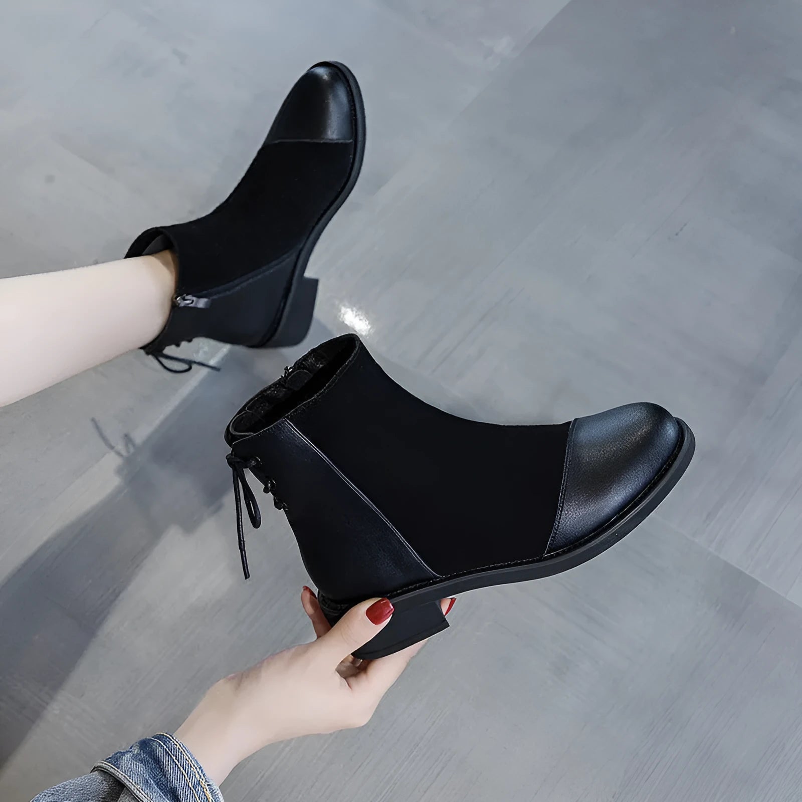 Black women's knee-high Martin boots with side zipper, round toe, and short stout heel.