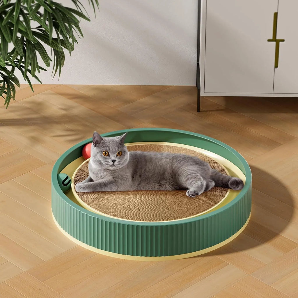 Large green circular cat scratching board with bell balls and a white spring toy in the centre.