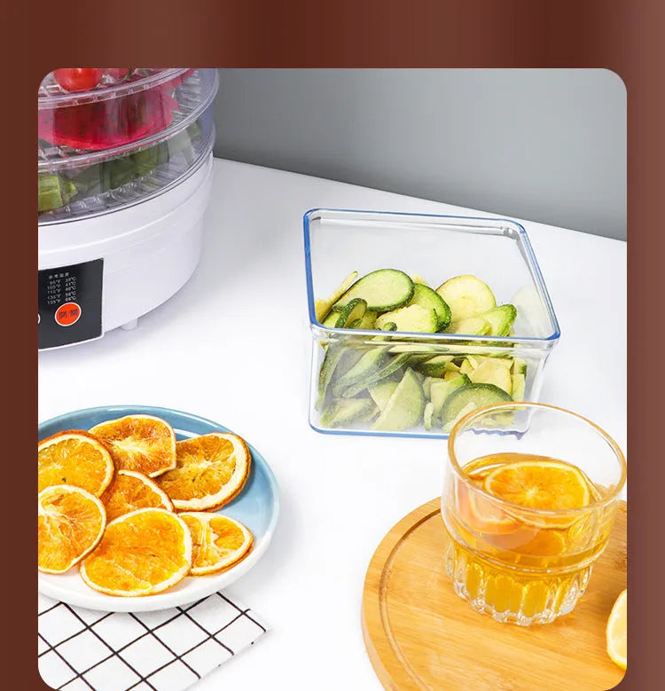 Household food dehydrator with multiple stackable drying trays on a kitchen worktop.
