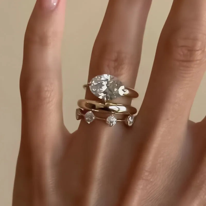 Gold electroplated minimalist ring with a row of small diamonds on silver band
