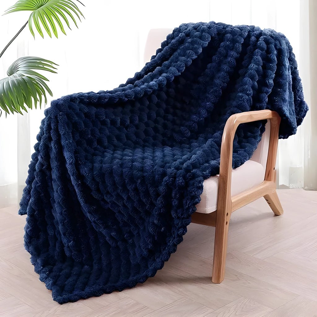 Children's soft plaid fleece blanket in camel colour showing texture and size.