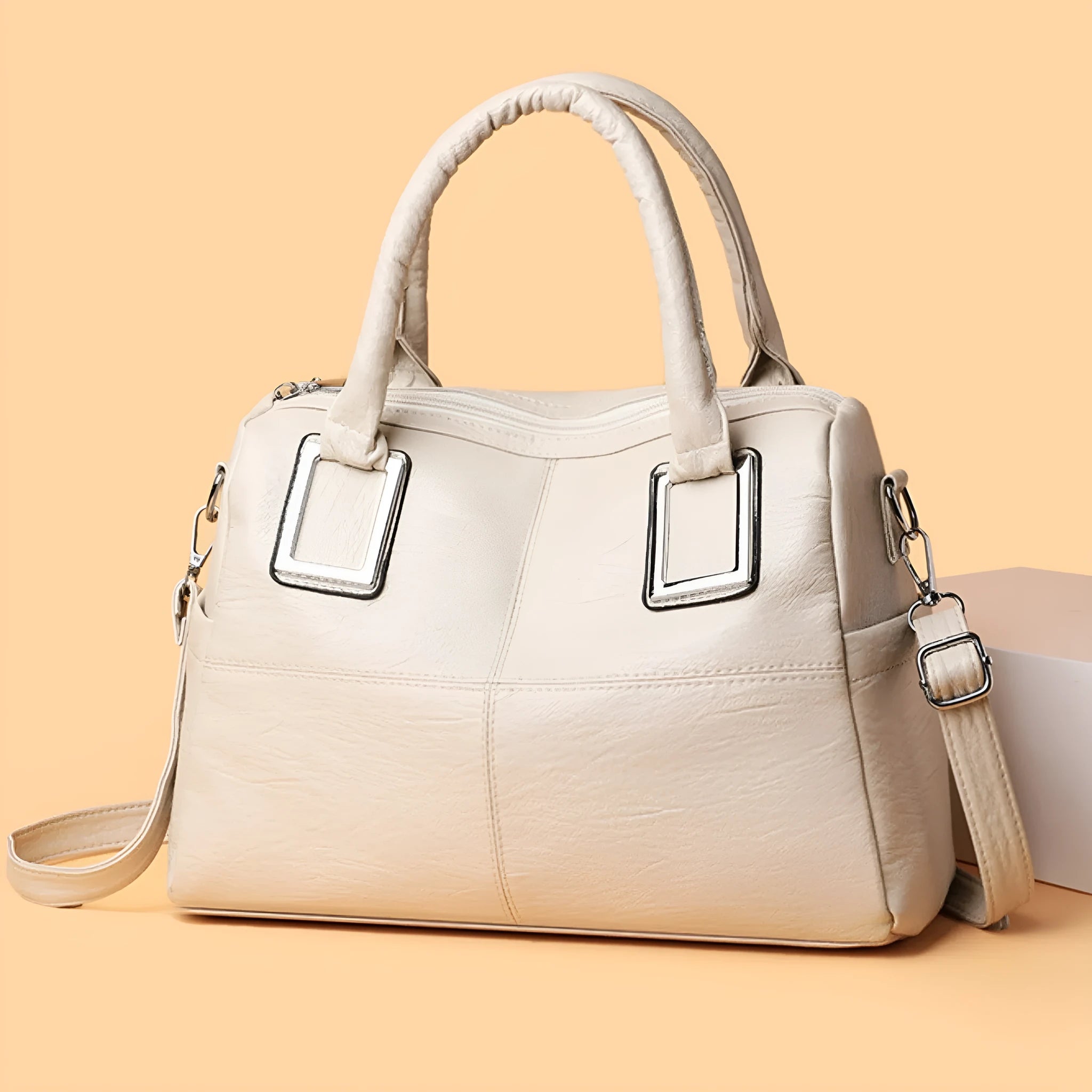 Women's square shoulder bag showing internal phone pocket and document compartment in neutral colour