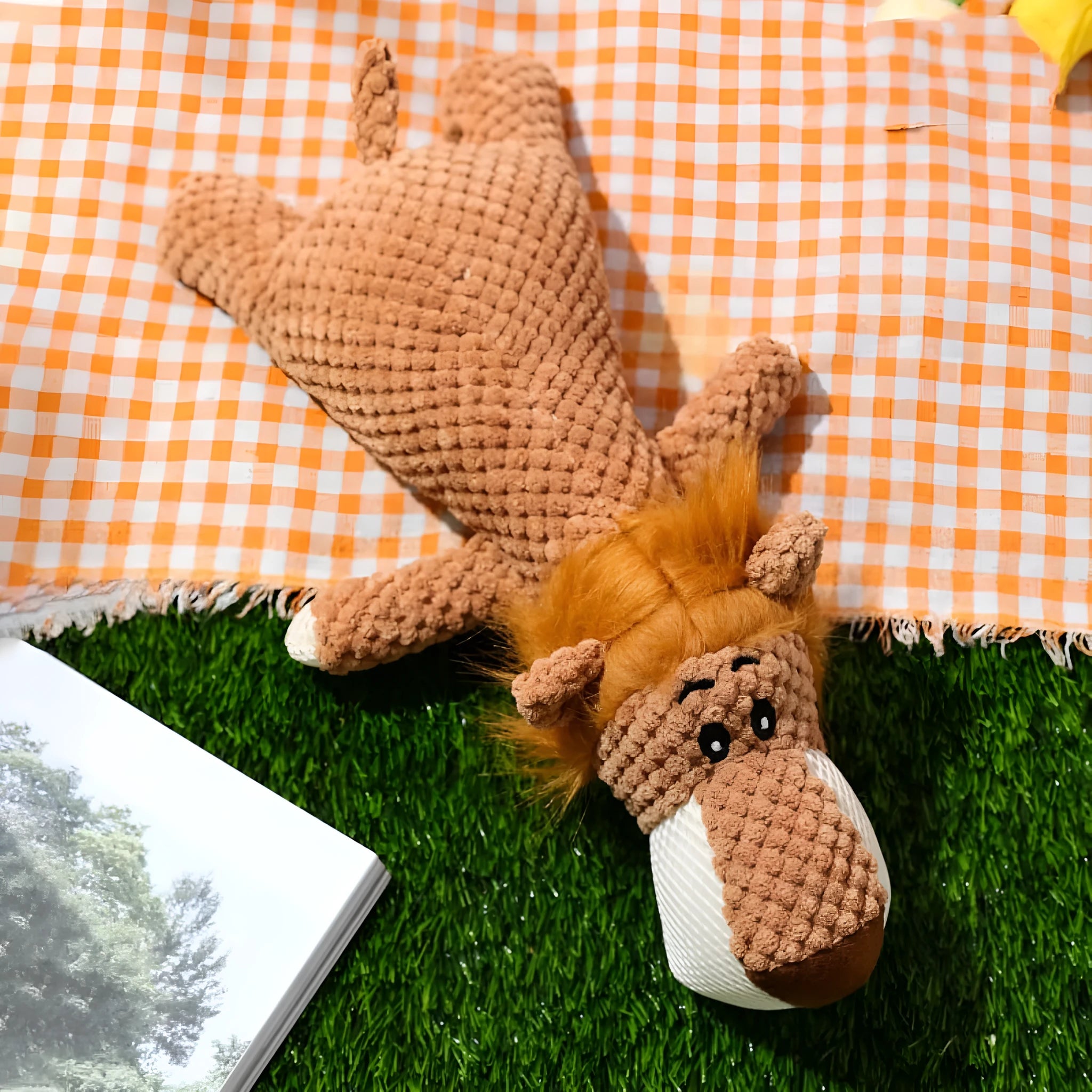 Green plush dog chew toy shaped like an animal with a corn kernel texture and a squeaker inside.