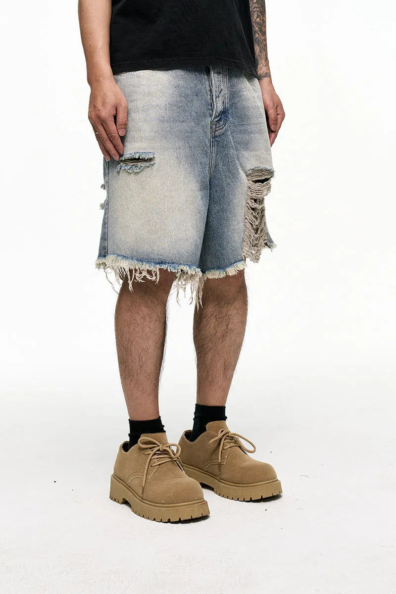 Light blue washed men's denim shorts with a baggy wide leg fit on a mid waist.