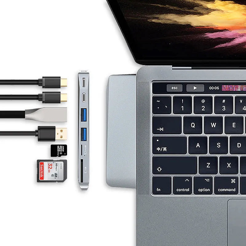 Silver 8-in-1 USB-C hub for MacBook Pro with multiple ports including USB 3.0, HDMI, and card slots