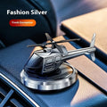 Silver metal solar helicopter car air freshener ornament rotating on dashboard
