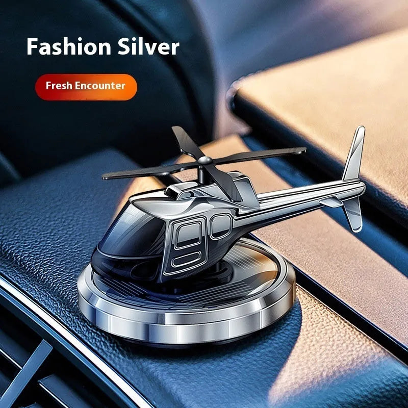Silver metal solar helicopter car air freshener ornament rotating on dashboard
