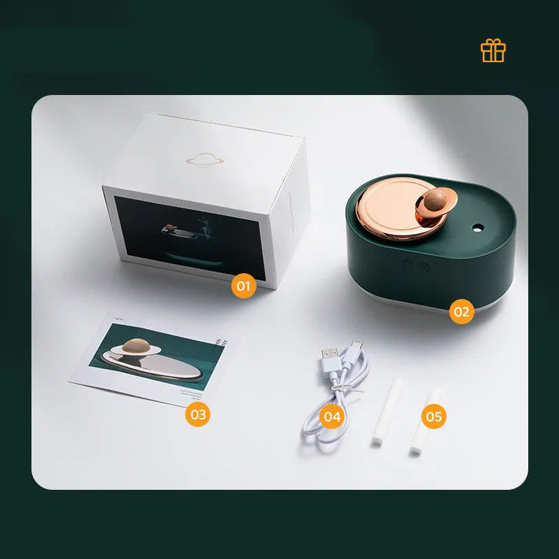 Green rotating planet USB portable humidifier with night light on a wooden desk.