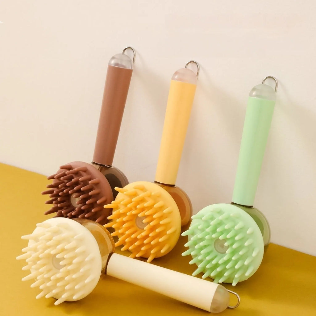Three 3-in-1 pet bath brushes in beige, blue, and green with shampoo dispensing handles and silicone bristles on white background
