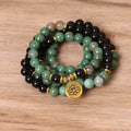 Women's green and black alloy elastic beaded bracelet on a wrist, showing natural style design.