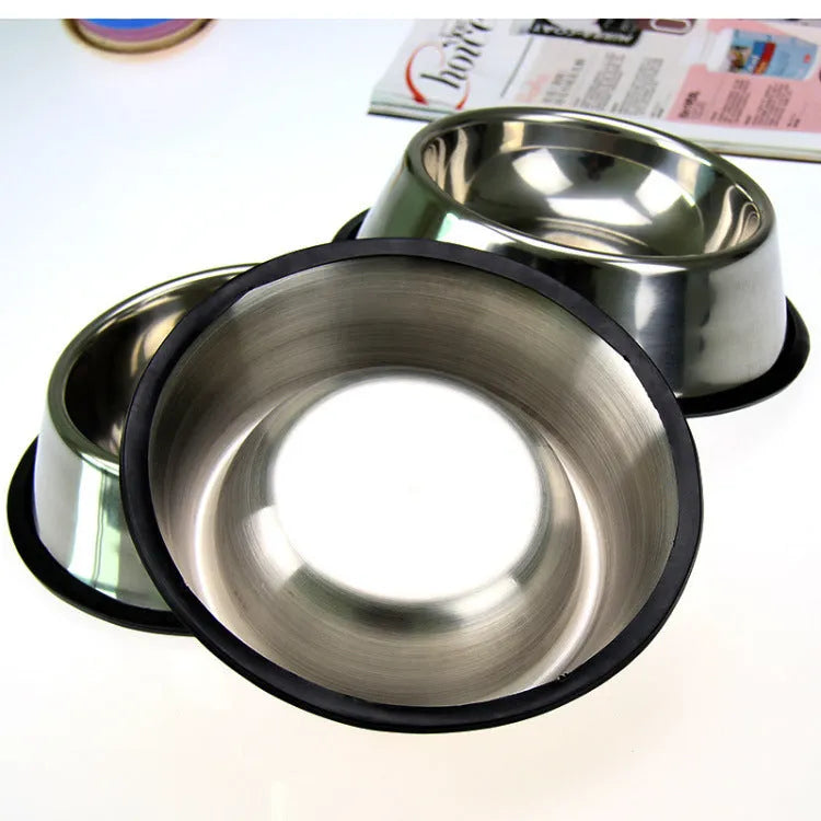 Classic stainless steel pet bowl with non-slip rubber base on a tiled floor