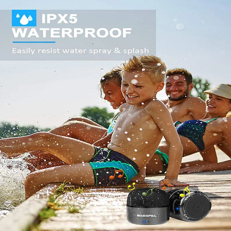 Small black waterproof portable Bluetooth speaker with control buttons.