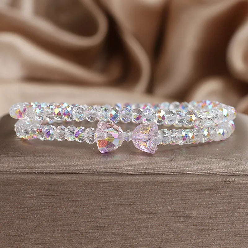 Women's double-circle crystal bow bracelet in white, green, and pink colour options on display