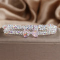 Women's double-circle crystal bow bracelet in white, green, and pink colour options on display