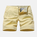 Men's straight-fit denim shorts in blue, shown on a hanger.