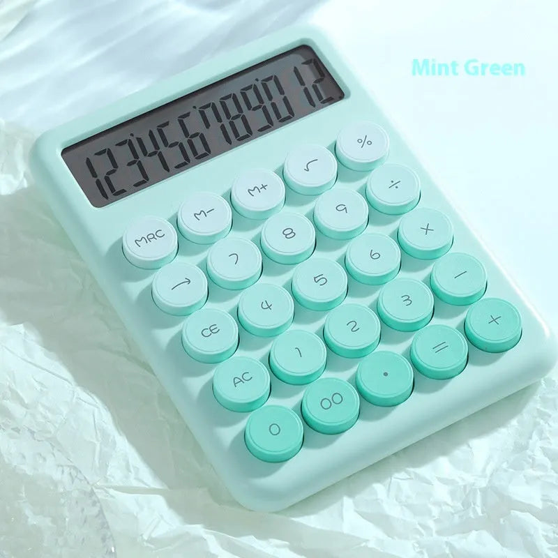 Desktop calculator with a gradient colour design in violet, blue, green, and pink tones on a white desk.