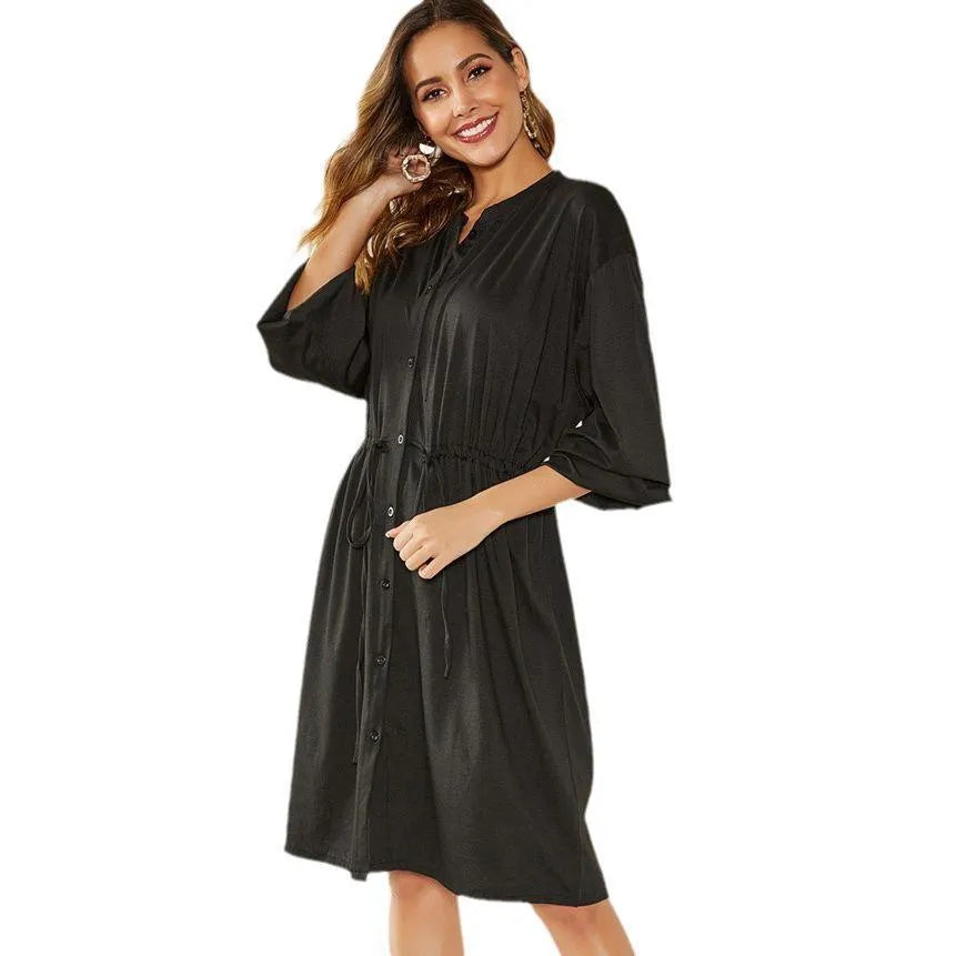 Black A-line mid-length dress with long sleeves, elastic waist, and a cinched belt.