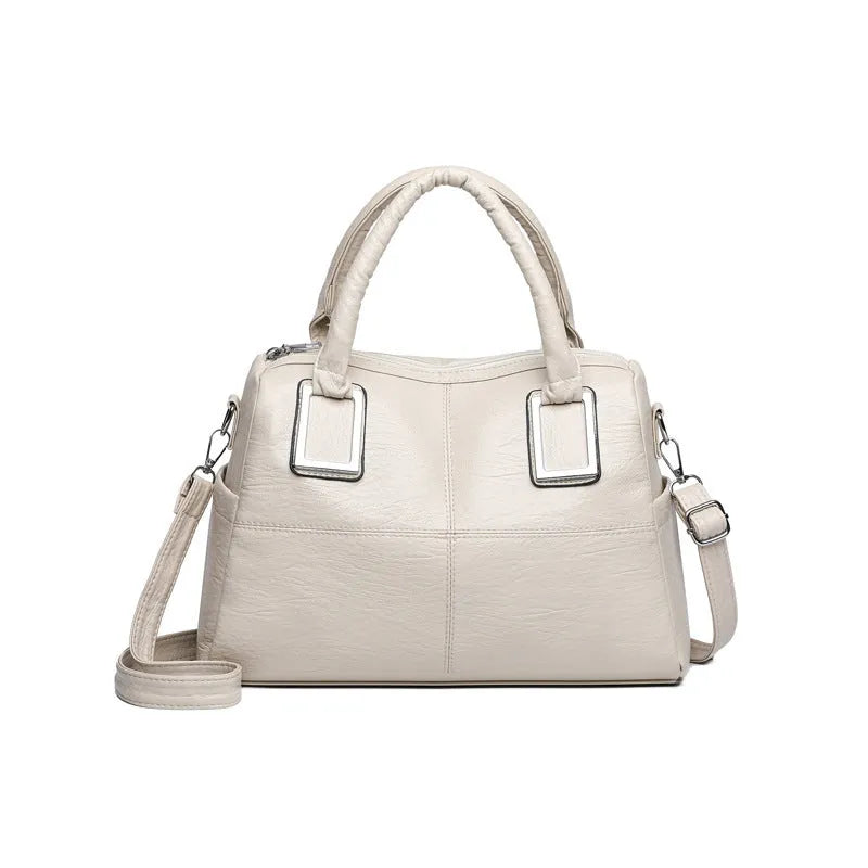 Women's square shoulder bag showing internal phone pocket and document compartment in neutral colour