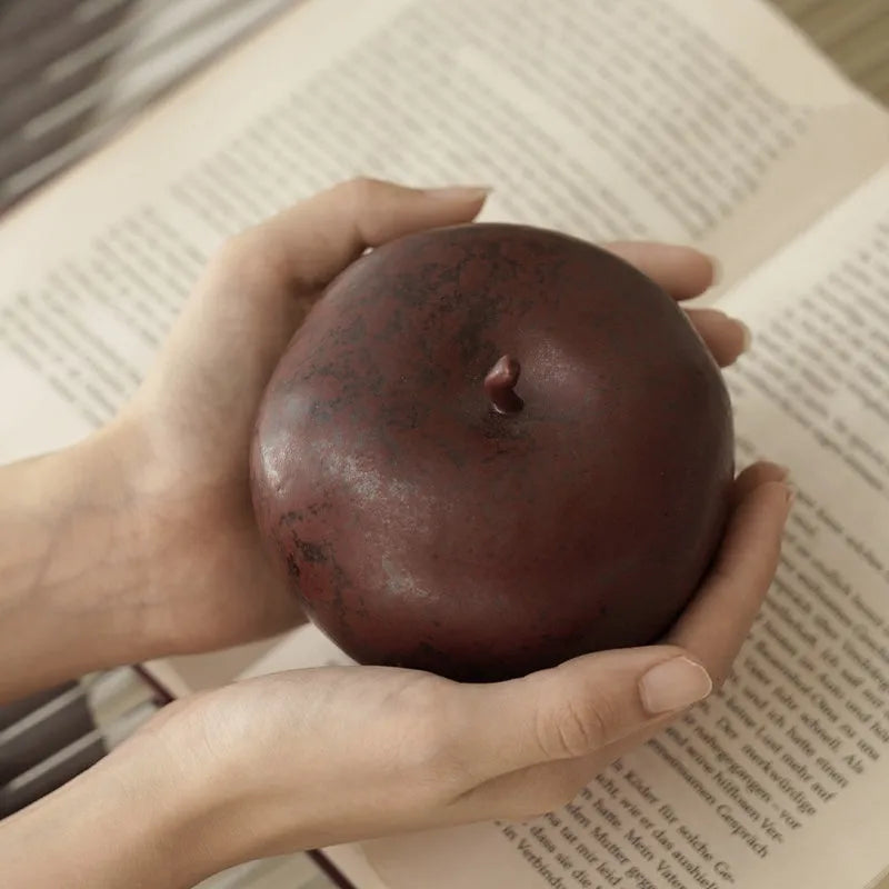 Ceramic apple decoration ornament on a desk, shown in large and small size options.