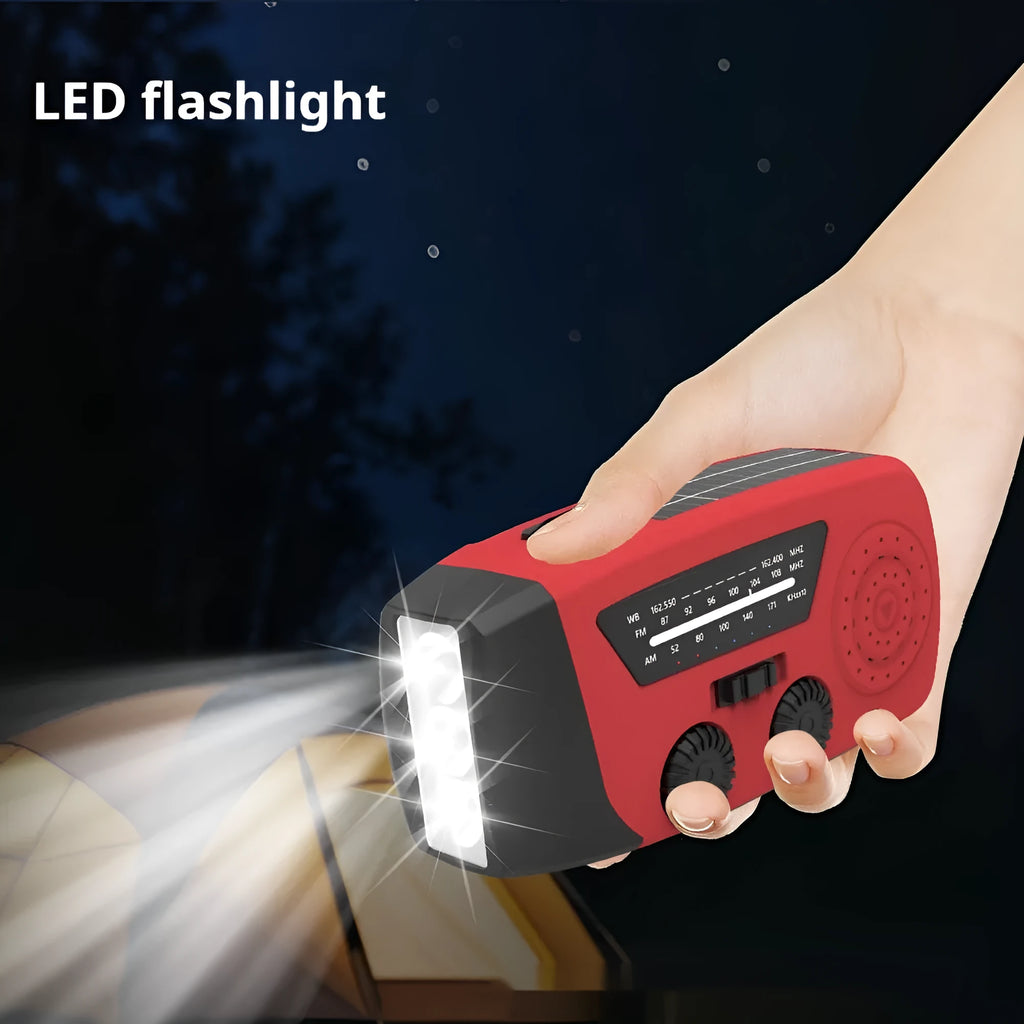 Red rechargeable handheld torch and radio unit with wrist strap and USB charging port.