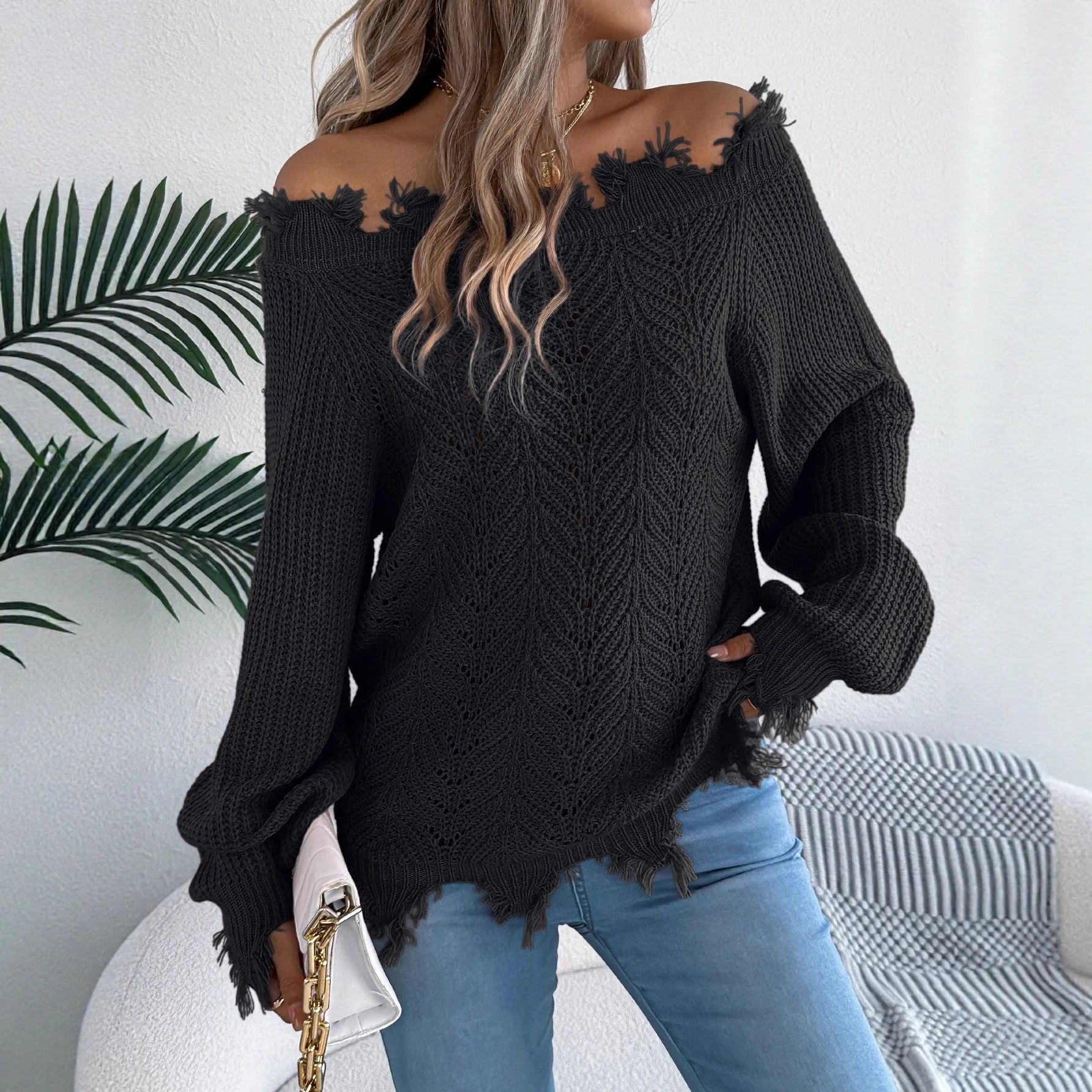 Women's white hollow-out pullover sweater with cut off-the-shoulder design and long sleeves