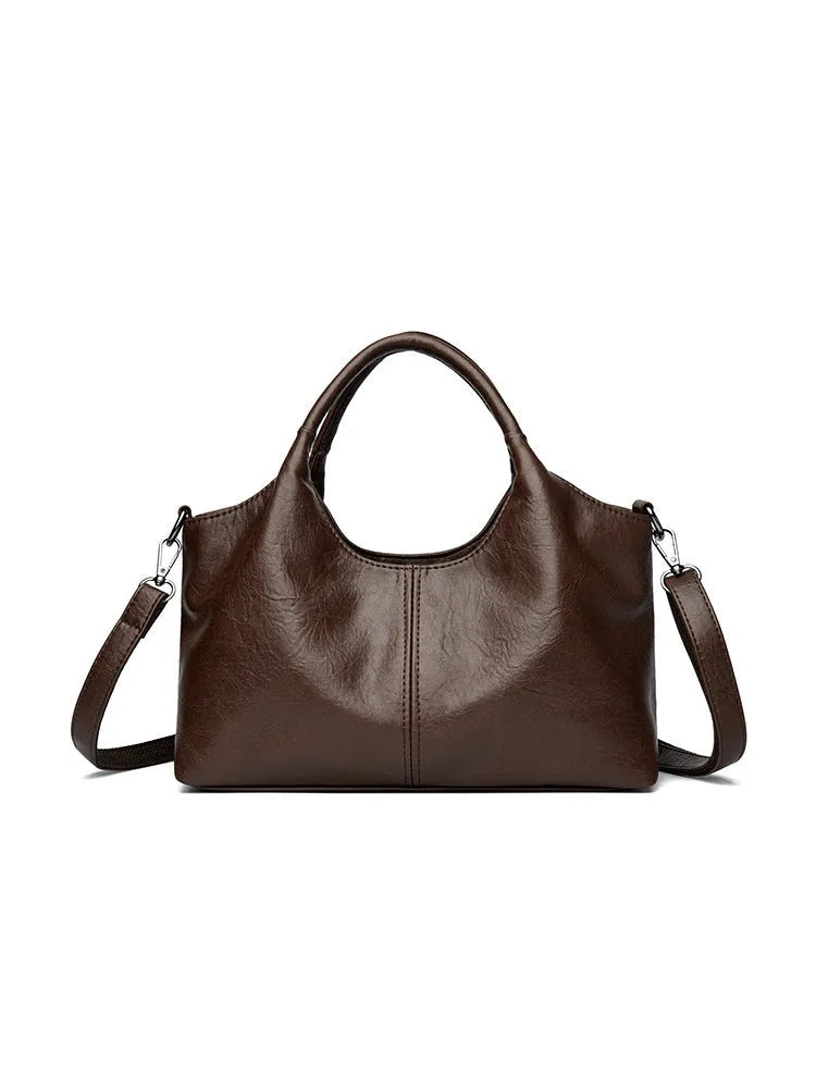 Women's genuine leather crossbody bag in beige colour showing soft construction and large capacity