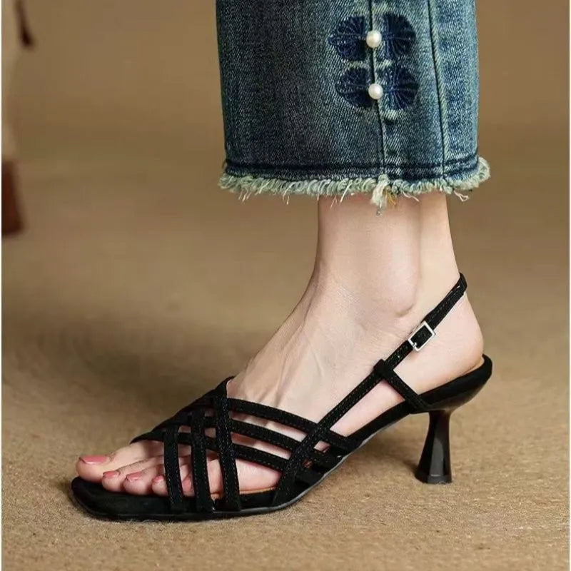 Women's light brown retro ankle-strap sandals with thin cross straps and a square toe on a mid heel.