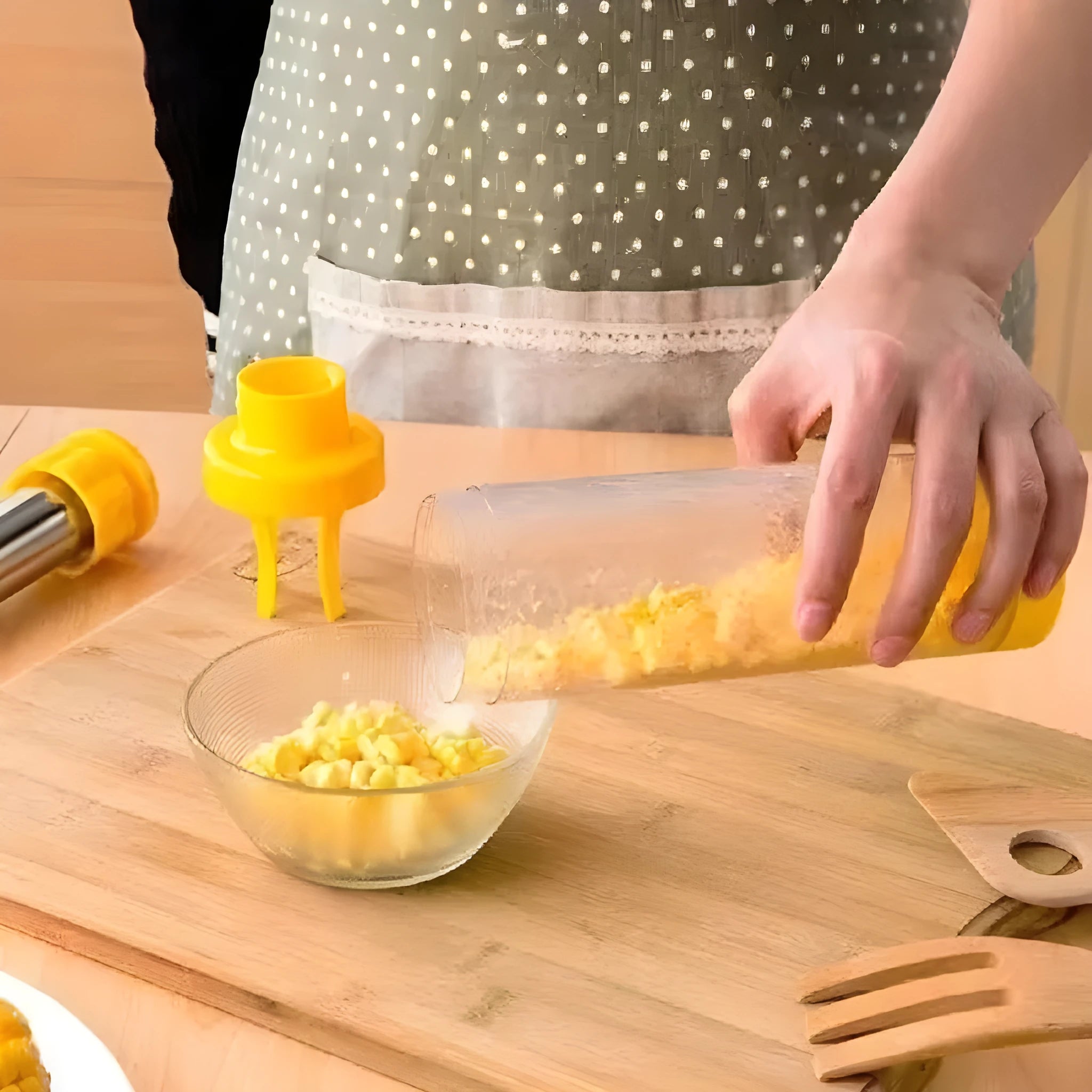 Yellow cylindrical corn stripper kitchen tool made of ABS plastic and stainless steel.