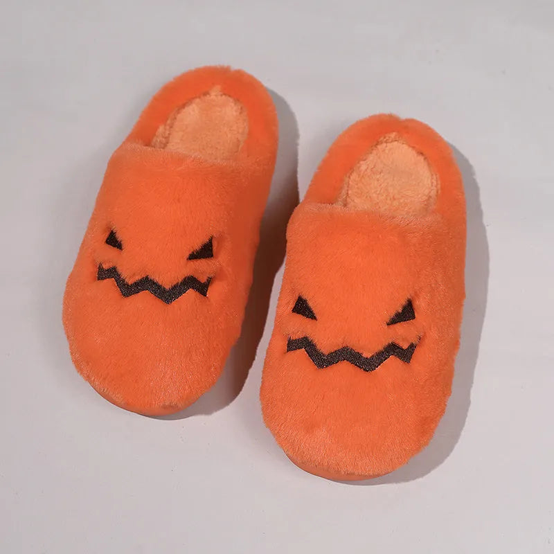 Orange coral velvet Halloween pumpkin slippers with plush lining and a grey non-slip PVC sole.