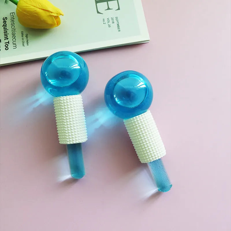Two blue ice wave balls with flash finish for facial massage on a light background.