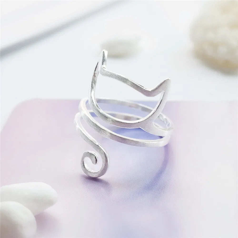 S925 silver adjustable cat ring with brushed winding design on a neutral background
