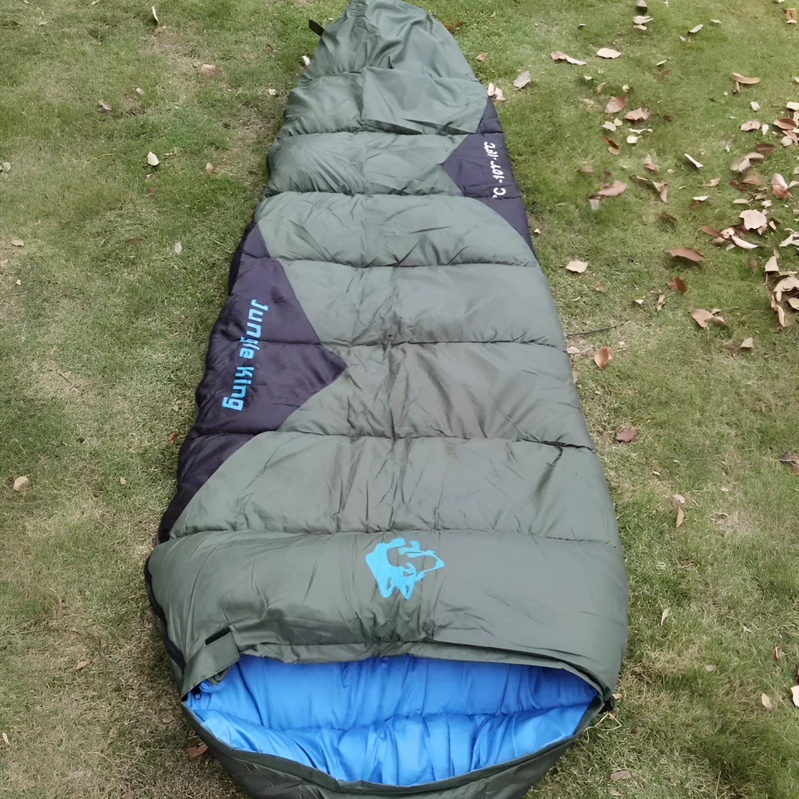Outdoor cotton sleeping bag in Army Green with its compression sack, sized 230cm long.