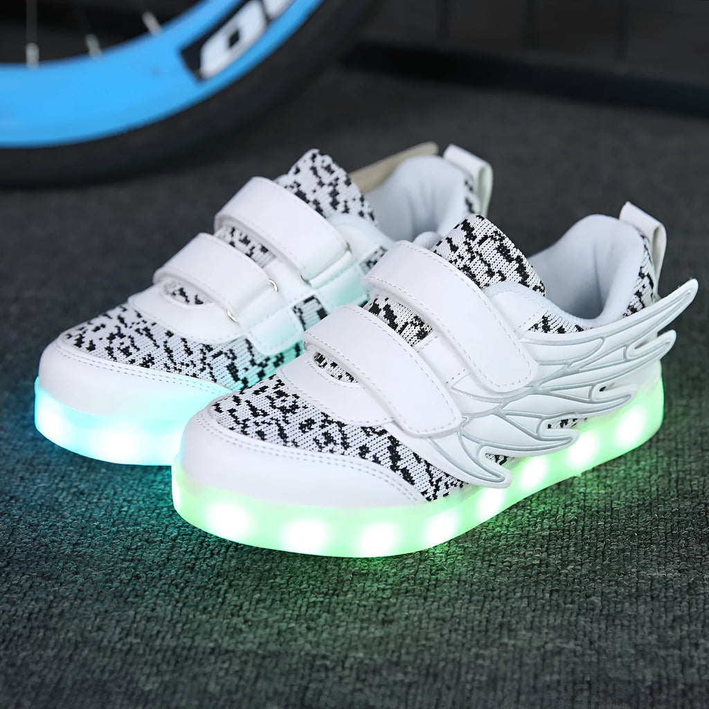 Plum red and white children's LED light-up sneakers showing USB charging port and hidden colour-selector switch.